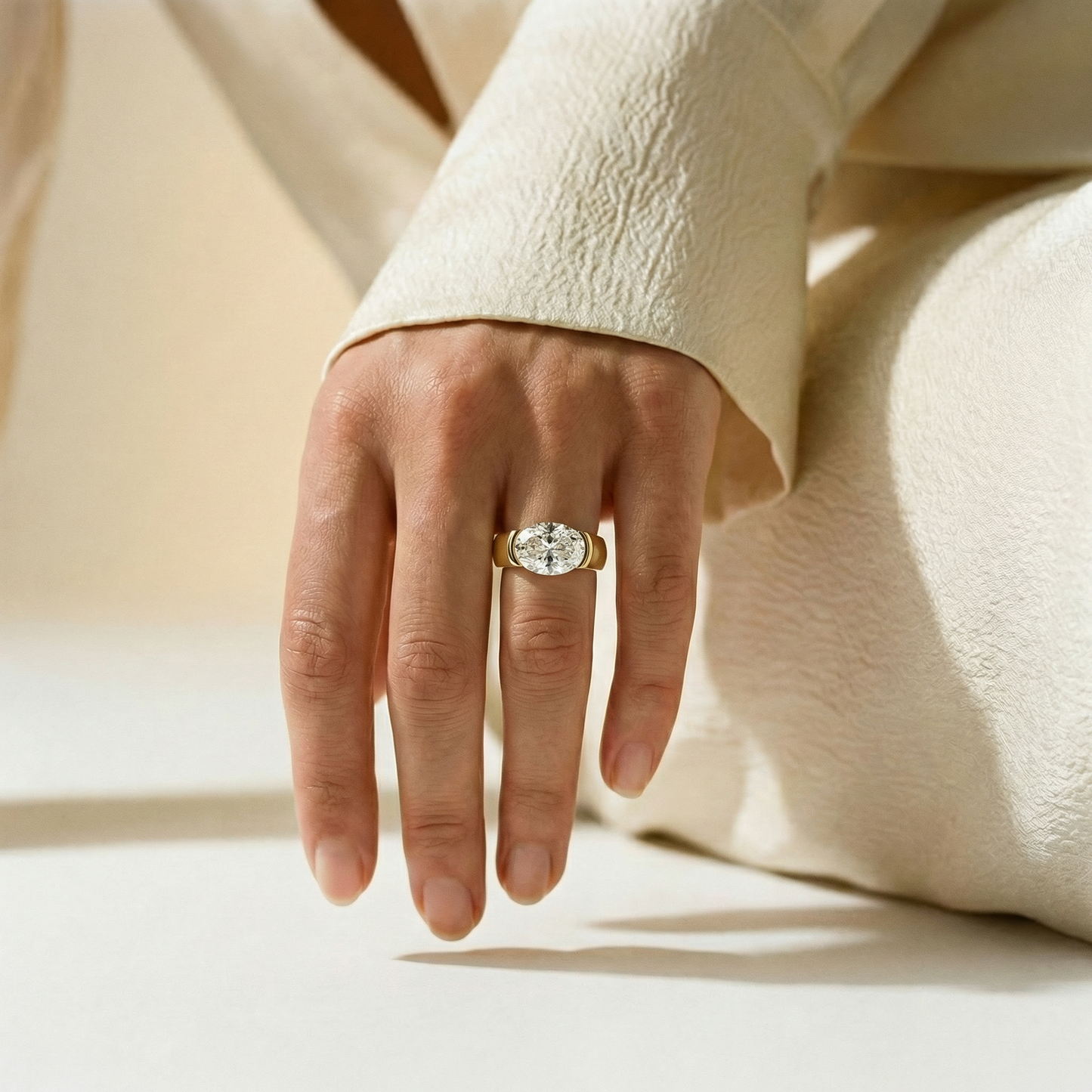 EAST WEST OVAL HALF BEZEL SOLITAIRE